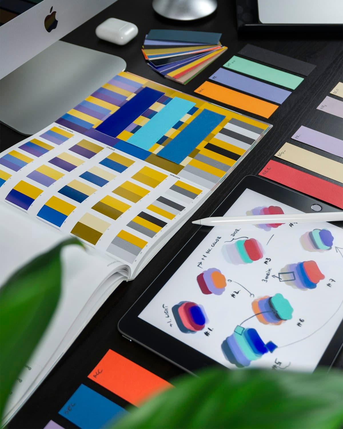 Design desk with color swatches, tablet, and stylus
