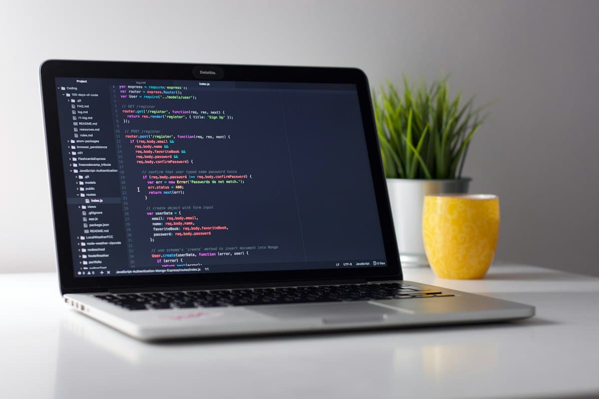 Laptop open to a code editor on a clean desk