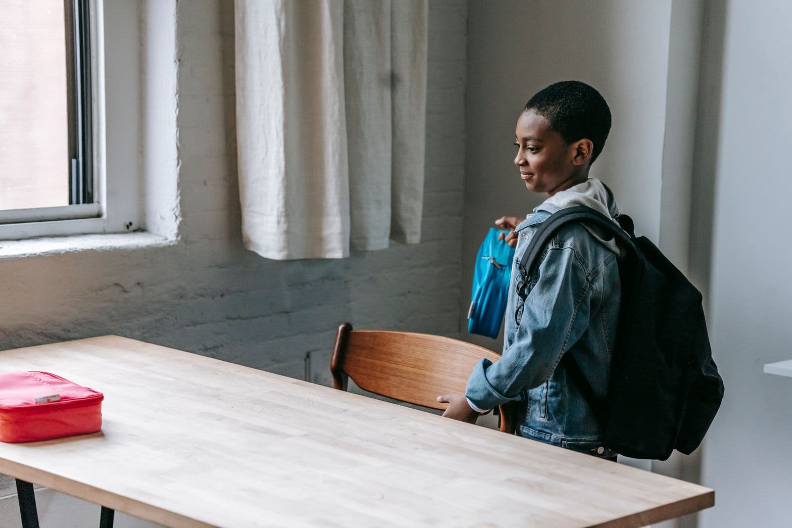 African schoolboy ready for class with backpack